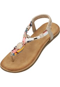 Sandalo piatto color tan con una soletta testurizzata, che presenta una fascia in tessuto con motivo floreale e dettagli dorati al centro.