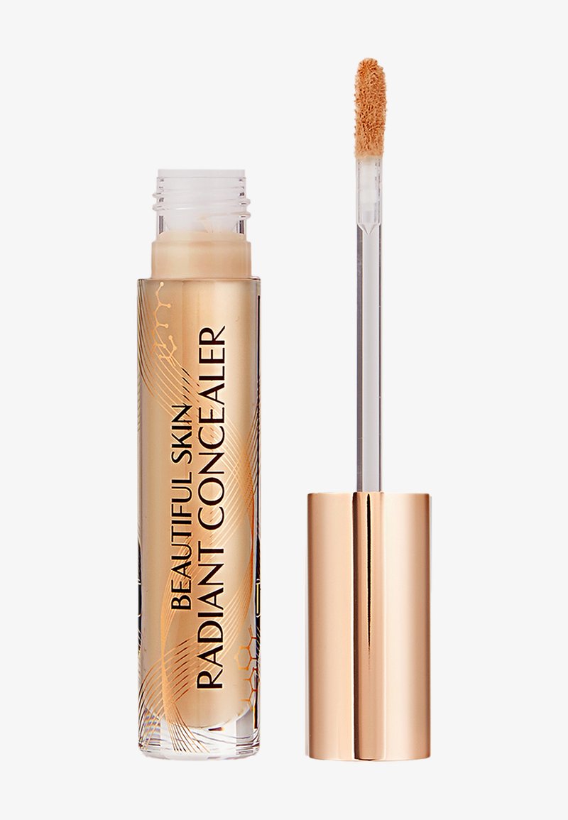 Transparente Tube mit beigem Flüssigconcealer, beschriftet mit "Beautiful Skin Radiant Concealer", mit goldfarbenem Deckel und Applikatorstäbchen.