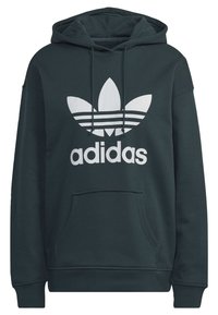 Mörkgrön hoodie med ficka fram, dragsko på huvan och en stor vit Adidas-logotyp med tre ränder och en bladdesign.