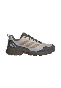 Chaussure de randonnée extérieure avec semelle robuste, matériaux synthétiques beige et vert olive, lacets noirs conçus pour la durabilité et l'adhérence.