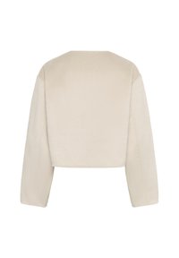 Cropped beige jacket made of soft fabric, featuring long sleeves and a rounded neckline. Smooth texture with a minimalistic design.