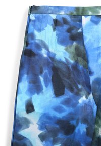 Blau- und grün gemusterter Stoff mit abstrakten Formen. Leichtes Material mit glatter Textur und sichtbaren Falten.