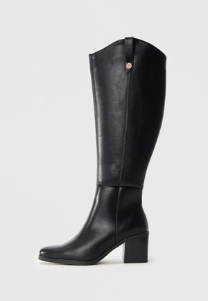 Black knee-high leather boots with a square toe and block heel. Features a side seam and a decorative metal accent at the top.