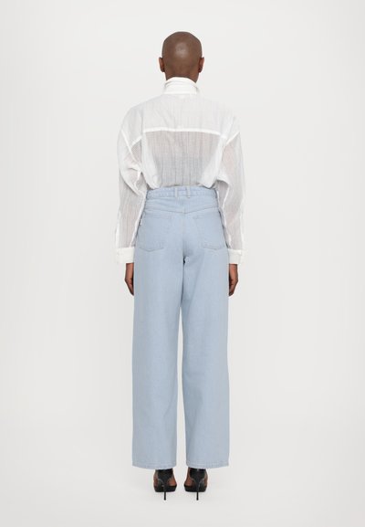 REMAIN COCOON PANTS - Široke nogavice - light blue