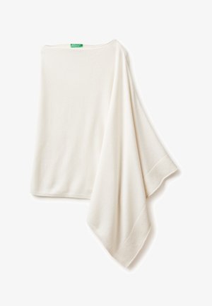Cream-colored wrap in soft, textured fabric. Features a wide neckline and ribbed edges, presenting a flowing, draped design.