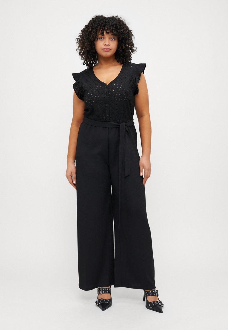 Black jumpsuit with short ruffled sleeves, button-down front, belted waist, and wide-leg design, featuring a textured fabric.