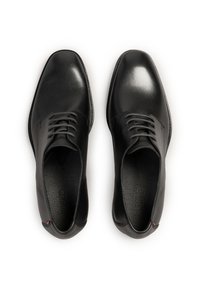 Schwarze Leder-Dressschuhe mit glatter Oberfläche, runder Zehenform und schmalen Schnürsenkeln. Texturiertes Innenfutter und dezente Nähte betonen das Design.