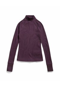 Lila långärmad polo med ribbad textur, raglanärmar och tumhål vid ärmsluten. Har logotyp på sidan.