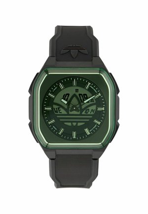 Melns digitāli-analogs sporta pulkstenis ar kvadrātveida zaļu rāmīti, Adidas logotipu ciparnīcā un gumijas siksniņu ar iestampētu logotipu pie augšas.