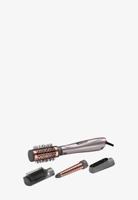 Spazzola per acconciature con dettagli in rosa dorato metallico, un manico affusolato, setole nere e tre accessori intercambiabili per lo styling in grigio.