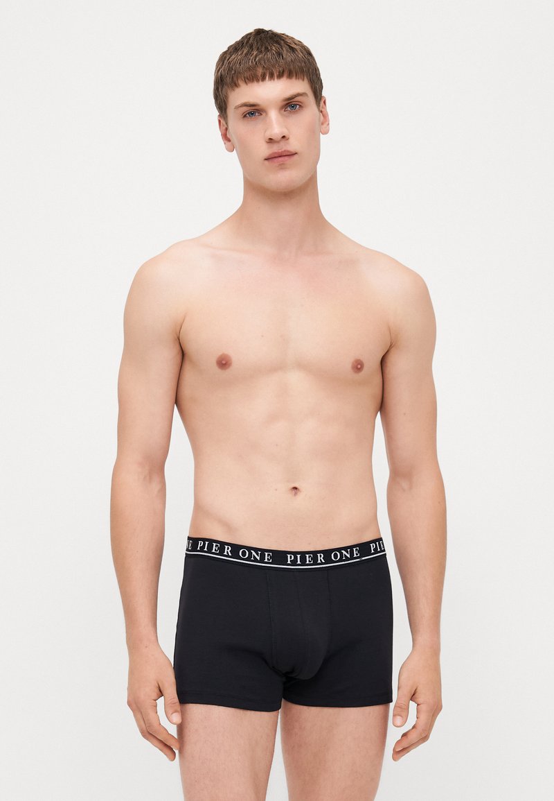 Black cotton boxer briefs with a white "PIER ONE" logo waistband. The fabric appears soft with a smooth texture. The fit is snug, designed for men.