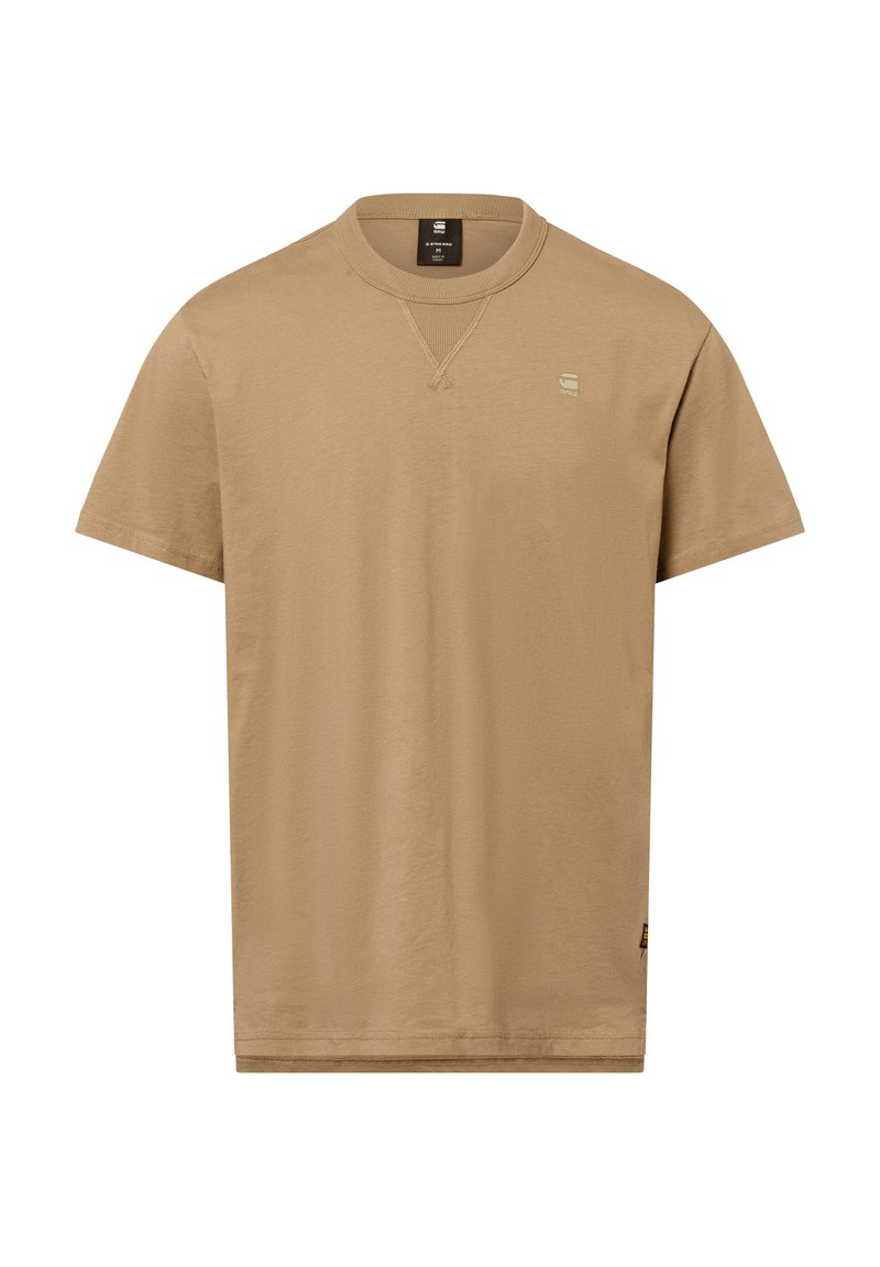 Camiseta de manga corta en un color beige claro, hecha de una tela suave. Presenta un cuello redondo y un pequeño logo bordado en el pecho.