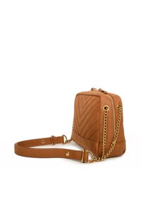 Tan leather handbag with a chevron quilted design, gold chain and strap accents, zip closure, and a rectangular shape.