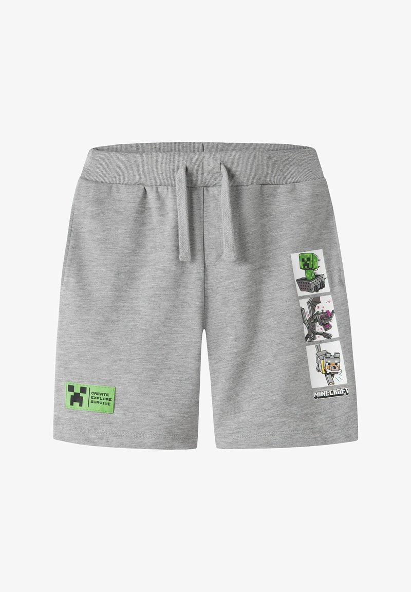 Short gris clair avec cordon, avec des personnages et le logo Minecraft sur la jambe droite, et un patch vert avec du texte sur la jambe gauche.