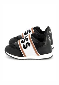 Black athletic shoes featuring a breathable mesh upper, large white and brown logo straps, and a white rubber sole.