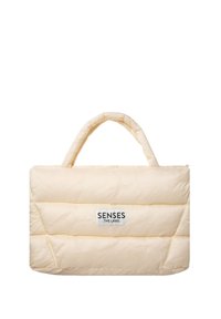 Gepolsterte cremefarbene Tragetasche mit zwei runden Griffen, die horizontale abgesteppten Abschnitte und ein Markenlabel auf der Vorderseite aufweist.