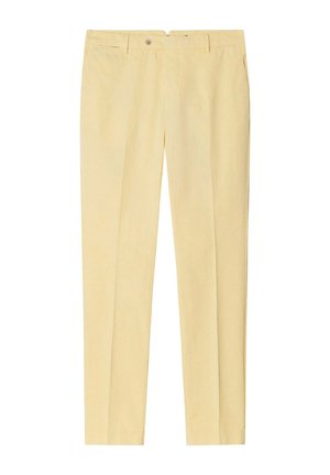 Beige op maat gemaakte broek met knoop aan de voorkant, riemlussen, zijzakken en geperste vouwen langs elke pijp.