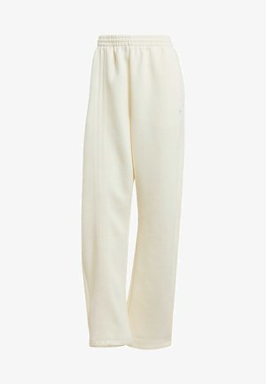 Pantaloni sportivi color crema con vestibilità comoda, vita elastica e strisce laterali. Texture liscia, senza motivi o accessori visibili.