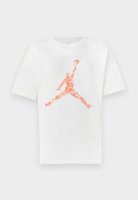 White cotton T-shirt featuring an orange floral Jumpman logo printed in the center. Crew neck design and short sleeves.