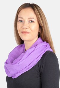 Purple scarf made of lightweight fabric, loosely draped around the neck. Has a soft texture and flowing design, enhancing visual appeal.