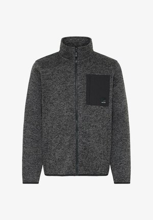 Halli halli soe fleece-jakk kõrge kaelusega, lukuga ees ja musta rinnataskuga. Omab tekstureeritud mustrit ja pihaääriseid.