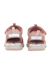 Sandalias rosa y beige con una suela gruesa blanca, que cuentan con correas ajustables y una parte superior de malla transpirable. Diseño abierto en la parte posterior para facilitar el uso.