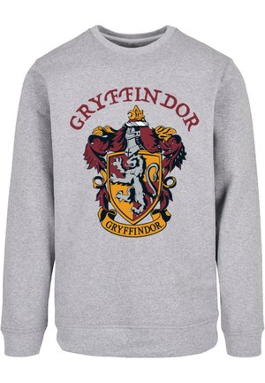 Hall sügava halli värvusega dressipluus, millel on punase, kollase ja musta tooni Gryffindori embleem, kus kujutatakse lõvi, krooni ja kerget detailide kujundust. Pehme, tekstuuriga kangas.