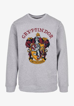 Pelēks dikts kreklis ar Gryffindor emocionālā emblēmu sarkans, dzeltens un melns, kurā attēlots lauvas, kronis un rullis. Mīksta, teksturēta auduma.