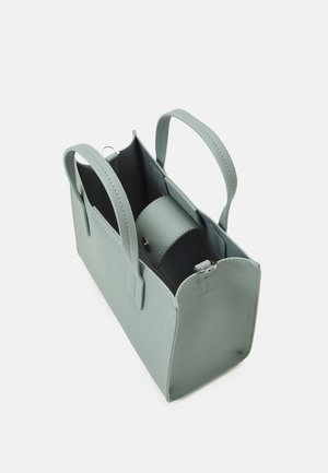 Sac à main en cuir vert clair avec deux poignées, ouverture sur le dessus et une pochette intérieure zippée à l'intérieur.