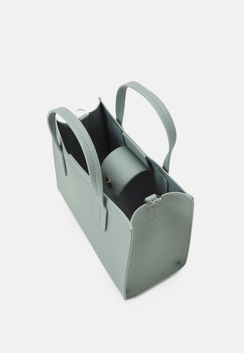 Sac à main en cuir vert clair avec deux poignées, ouverture sur le dessus et une pochette intérieure zippée à l'intérieur.