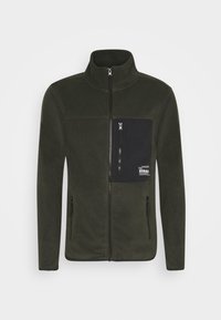 Fleece jacket in dark green with a high collar, full front zipper, and a black chest pocket featuring a logo. Two side zippered pockets.