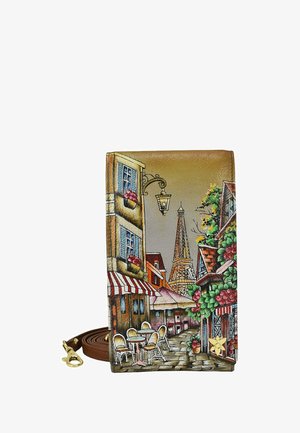 Brown leather wallet featuring a Parisian street scene with cafes, a lantern, and the Eiffel Tower. Vibrant colors and detailed design.
