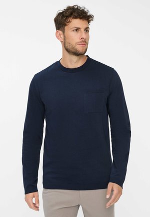 Marineblå langærmet t-shirt lavet af bomuld med rund halsudskæring og en brystlomme. Glat tekstur og tætsiddende design.
