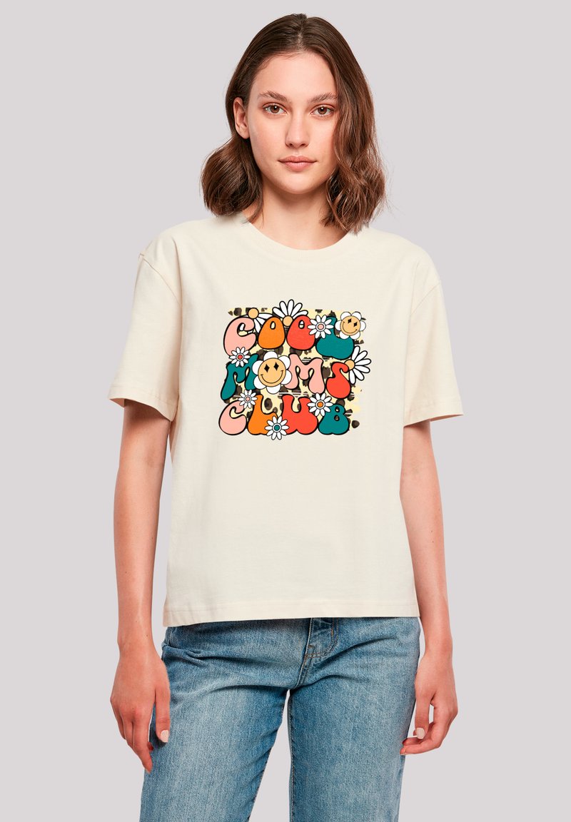 Cream cotton t-shirt featuring a colorful graphic design with the text "Cool Moms Club," flowers, and smiley faces. Short sleeves, relaxed fit.