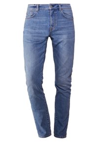 Smaljeans i blekt blå denim. Femfickorsdesign med dragkedja och knappstängning. Lätt slitningar på låren. Mjuk textur.