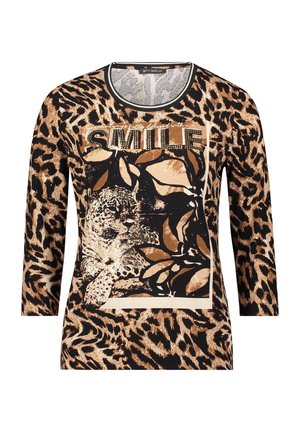 Langsleeve top met een luipaardprint in beige en zwart, voorzien van een centrale "SMILE" grafiek in rhinestones. Zacht materiaal, ronde hals.