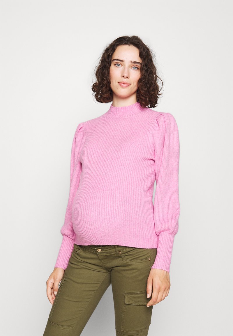 Light pink ribbed knit sweater with a high neckline, puffed sleeves, and a fitted body, paired with olive green cargo pants.