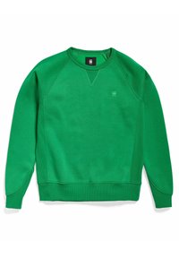 Sudadera verde de tejido suave con escote redondo, mangas raglán y puños de canalé. Presenta un pequeño logo en el pecho.