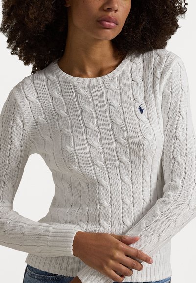 White cable-knit sweater featuring a ribbed crew neckline and cuffs, with a small blue logo accent on the chest. Soft, textured material.