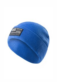 Blue knitted beanie with a ribbed texture and a black rectangular label featuring white text and coordinates.