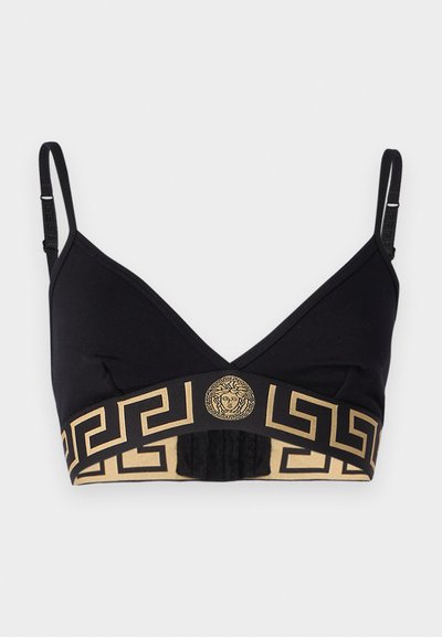 Black bralette with a gold Greek key pattern along the band, featuring a central Medusa logo and adjustable straps for fit.
