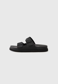 Black rubber slide sandal with two adjustable straps, a textured footbed, and a flat sole. Minimalist design with clean lines.