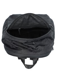 Sac à dos noir avec extérieur en nylon, fermeture à glissière, et intérieur spacieux doublé d'un tissu à motifs comportant le nom de la marque.