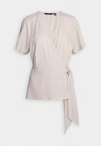 Top envolvente de color beige claro con mangas cortas, con un escote en V y un lazo en el costado. Fabricado con una tela suave y texturizada que se drapea con suavidad.