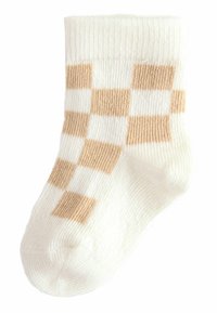 Vita strumpor med ett rutmönster i beige, med ribbad struktur och förstärkt tå. Mjukt material och design som går upp till vaden.