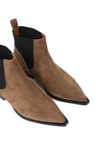 Brązowe zamszowe botki za kostkę z wydłużonym noskiem, czarnymi elastycznymi wstawkami po bokach, niskim obcasem i prostym, nowoczesnym wzornictwem.