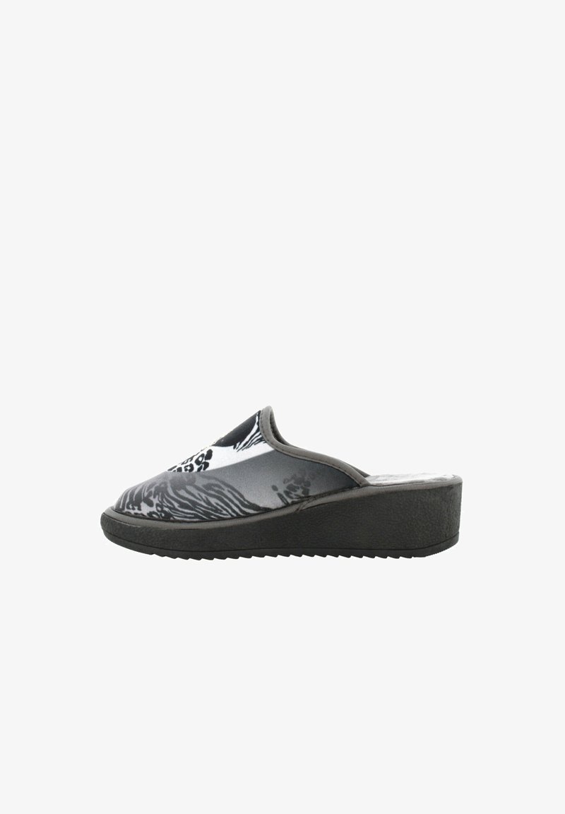 Zoccoli slip-on a fantasia bianca e nera con una tomaia liscia, suola a zeppa e suola in gomma texture per una migliore aderenza.