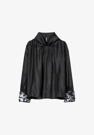 Schwarzes, strukturiertes Oberteil mit drapiertem Schalkragen, langen Ärmeln und silbernen Paillettenakzenten an den Bündchen. Rückenöffnung mit Knopfverschluss.