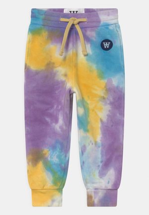 Pantalon de survêtement tie-dye pour enfants en violet, jaune, bleu et blanc avec ceinture élastique, cordon jaune et petit écusson rond avec logo.