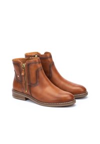 Brown leather ankle boots with a smooth texture, side zippers, and minimal stitching detail. Low stacked heel. Durable rubber sole.